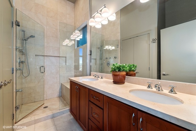 2029 West Rice Street, Unit 3 Chicago, IL 60622 - Photo 6 of 11 a bathroom with a double vanity sink mirror and shower