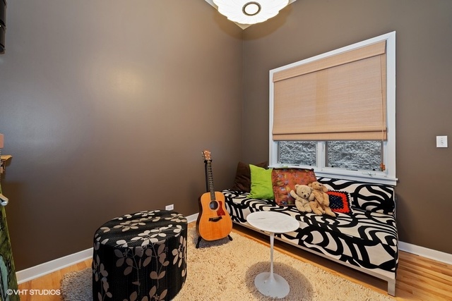 2029 West Rice Street, Unit 3 Chicago, IL 60622 - Photo 7 of 11 a bedroom with furniture and a window