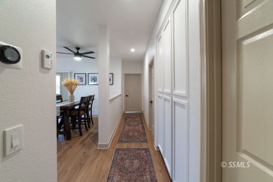 925 West Coronado Avenue Ridgecrest, CA 93555 - Photo 14 of 33 a view of a hallway with wooden floor and a chandelier