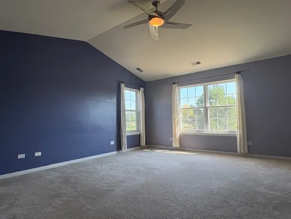 a view of a livingroom with a ceiling fan and window