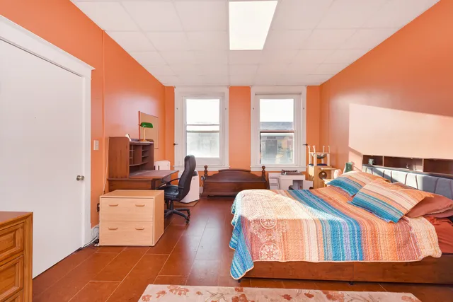 a living room with furniture and large windows