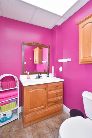 a bathroom with a sink mirror vanity and toilet
