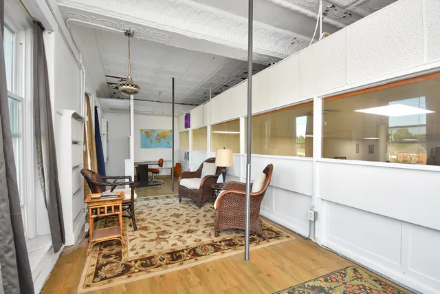 a dining room with lots of furniture and chandelier