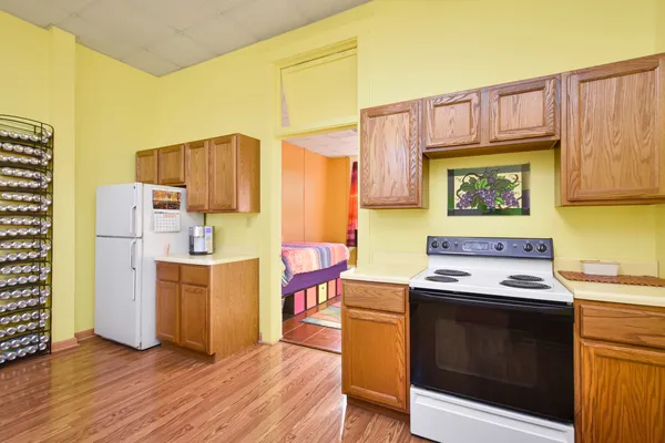 a kitchen with a stove a refrigerator and a stove top oven