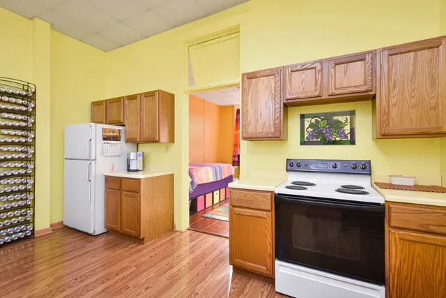 a kitchen with a stove a refrigerator and a stove top oven