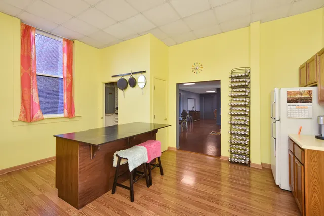a dining room with furniture and wooden floor