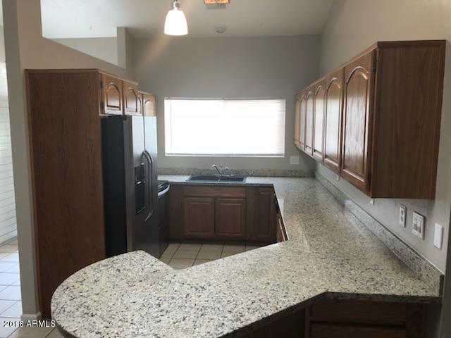 4008 West Davidson Lane Phoenix, AZ 85051 - Photo 3 of 12 a kitchen with a refrigerator and a sink