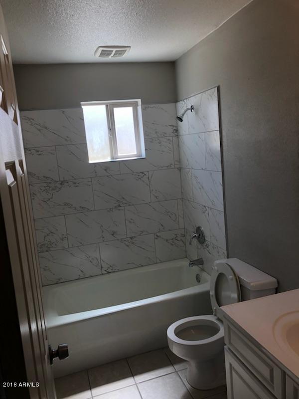 4008 West Davidson Lane Phoenix, AZ 85051 - Photo 5 of 12 a bathroom with a sink and a toilet