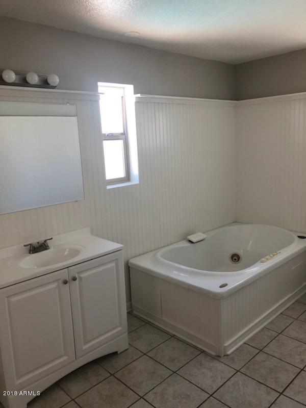 4008 West Davidson Lane Phoenix, AZ 85051 - Photo 8 of 12 a bathroom with a sink and a bathtub