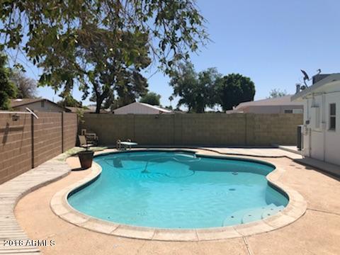 4008 West Davidson Lane Phoenix, AZ 85051 - Photo 10 of 12 a view of a swimming pool with an outdoor seating and yard