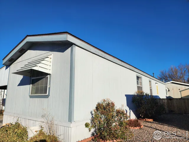 a kitchen with kitchen island a stove a sink a refrigerator and cabinets