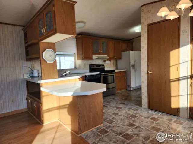 a kitchen with stainless steel appliances granite countertop a stove and a microwave