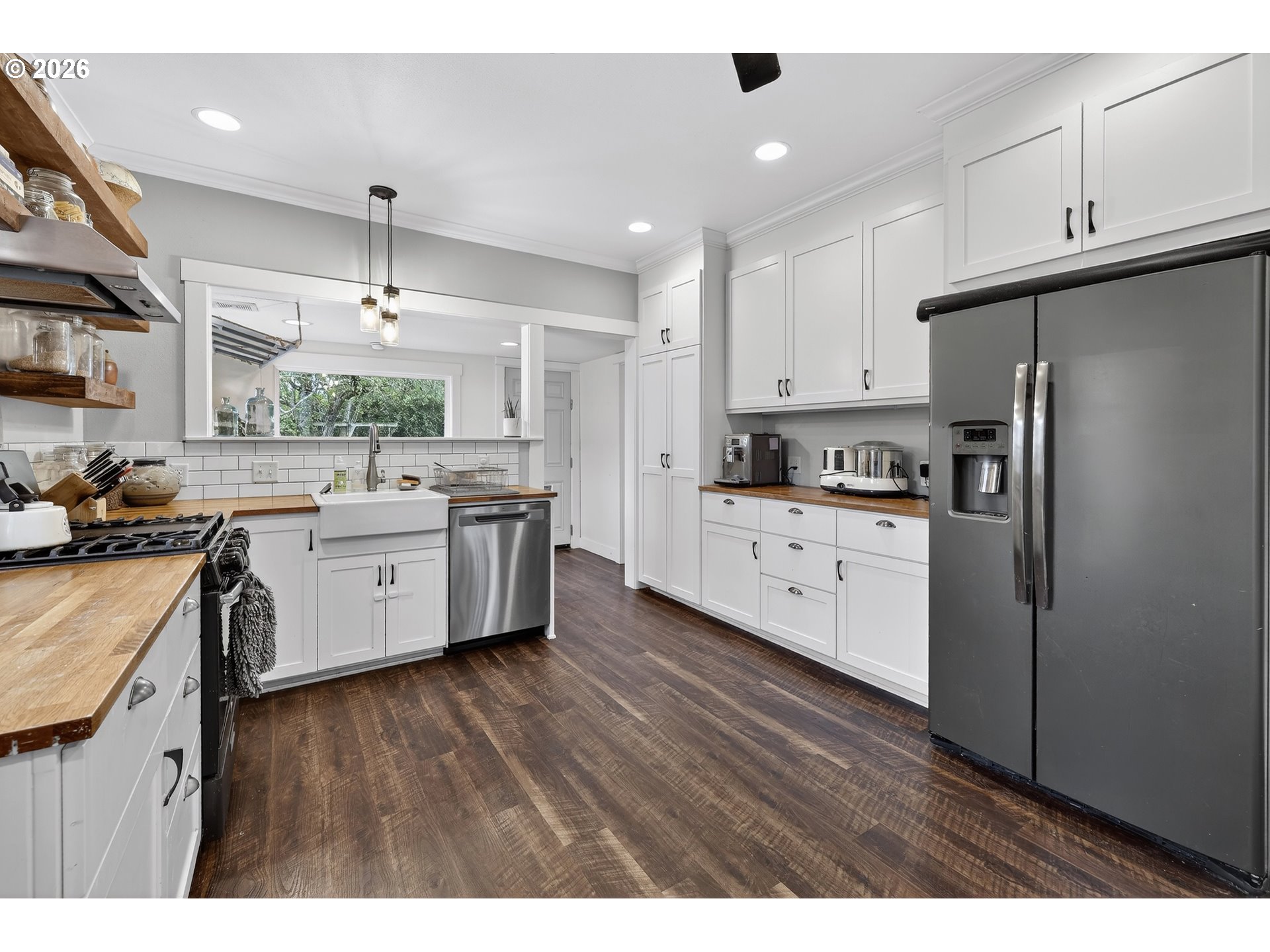 352 21st Street Northeast Salem, OR 97301 - Photo 13 of 41 a kitchen with stainless steel appliances a sink a stove a refrigerator cabinets and wooden floor