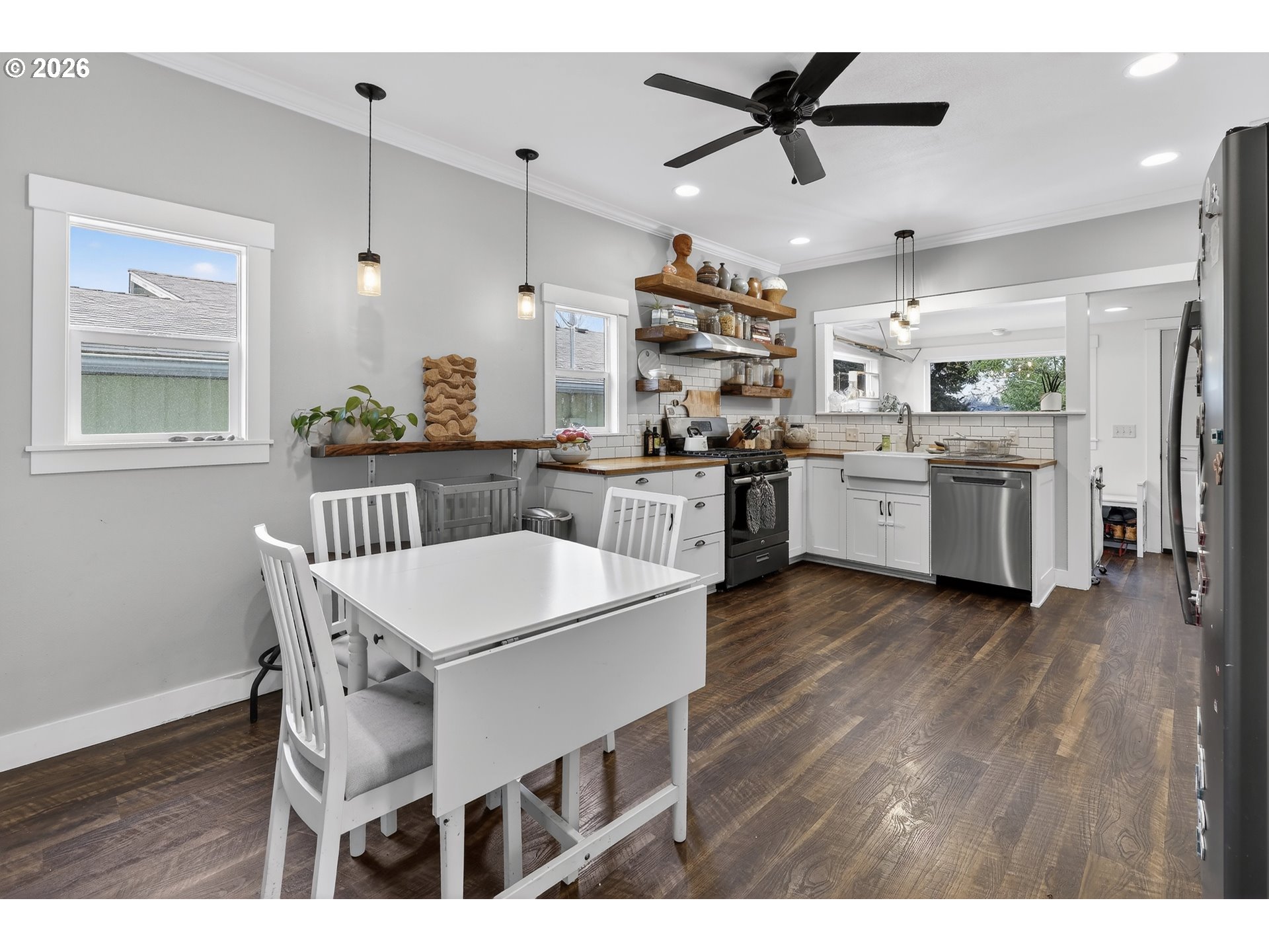 352 21st Street Northeast Salem, OR 97301 - Photo 8 of 41 a kitchen with kitchen island a dining table chairs stainless steel appliances and wooden floor