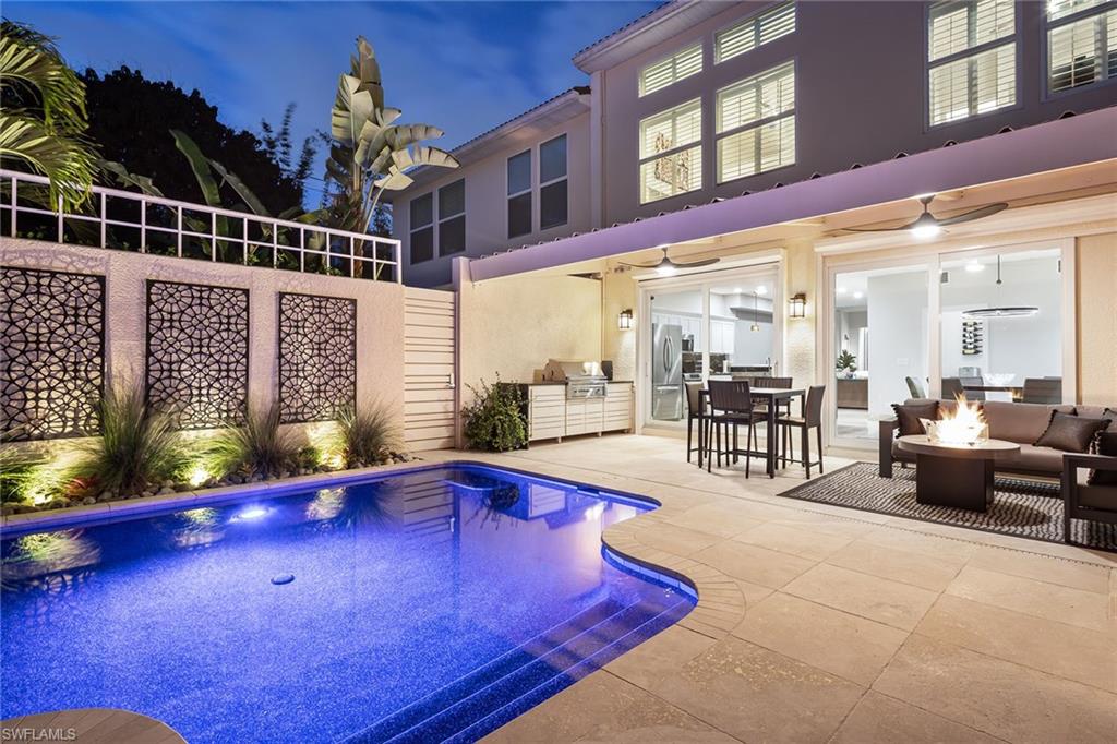 a view of a patio with swimming pool table and chairs