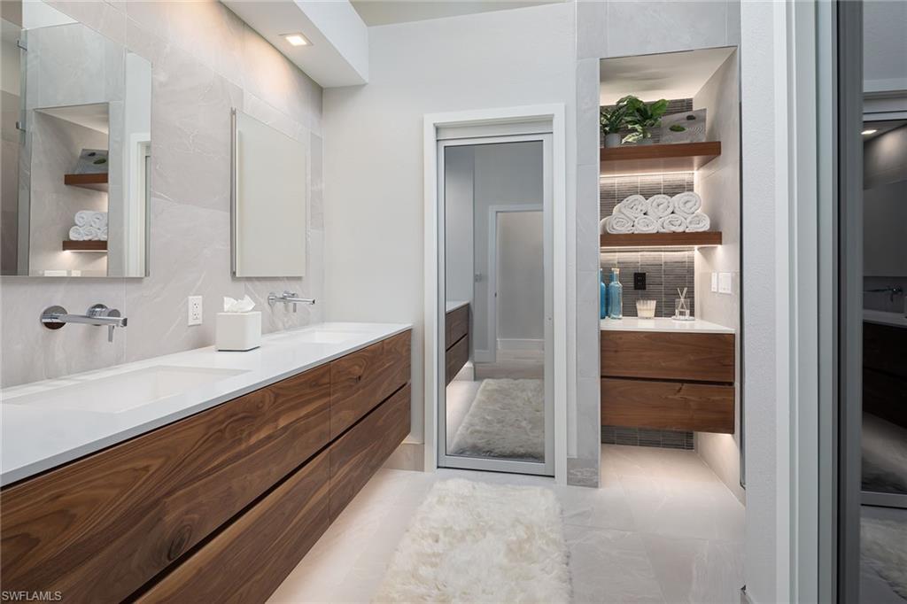 1070 5th Street South Naples, FL 34102 - Photo 11 of 23 a bathroom with a double vanity sink and a mirror