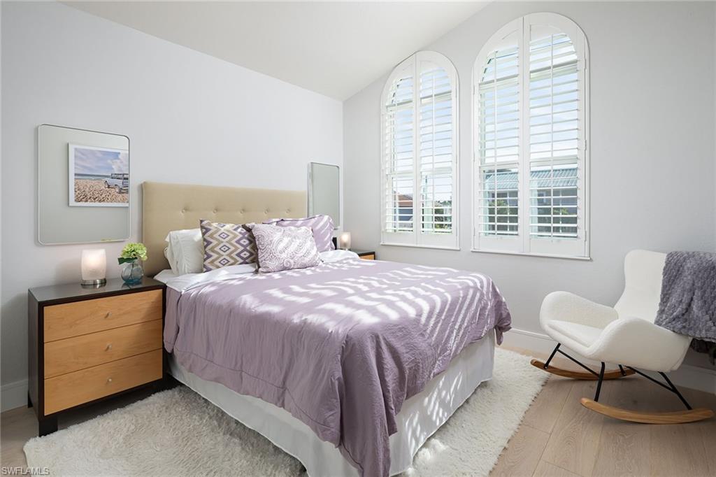 1070 5th Street South Naples, FL 34102 - Photo 16 of 23 a bedroom with a bed and a chair