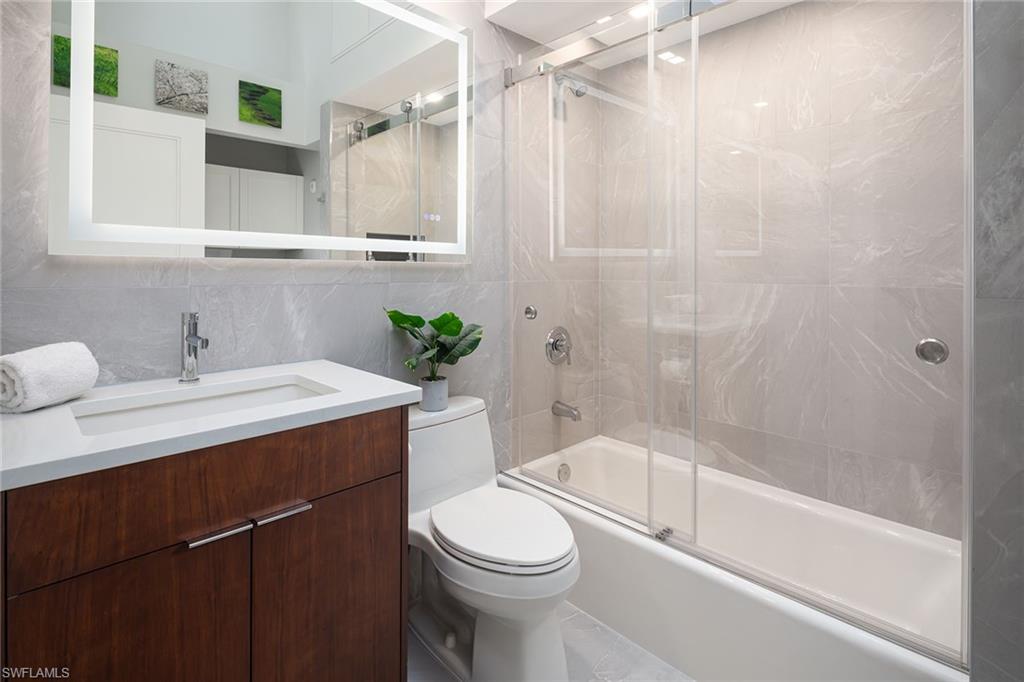 1070 5th Street South Naples, FL 34102 - Photo 17 of 23 a bathroom with a sink a toilet and shower