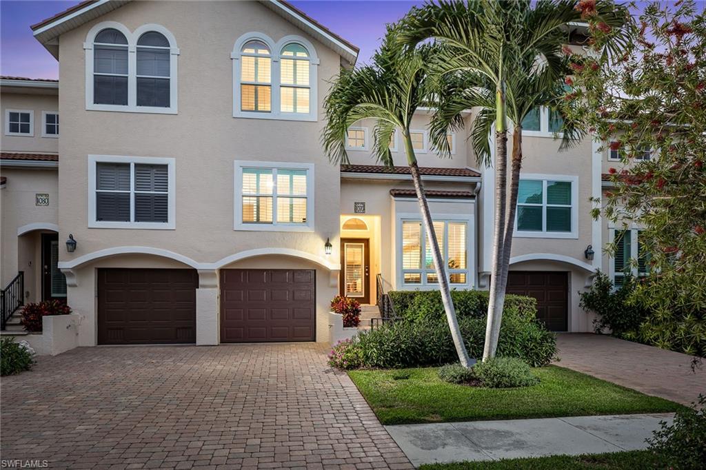 1070 5th Street South Naples, FL 34102 - Photo 22 of 23 a front view of a house with a yard and garage