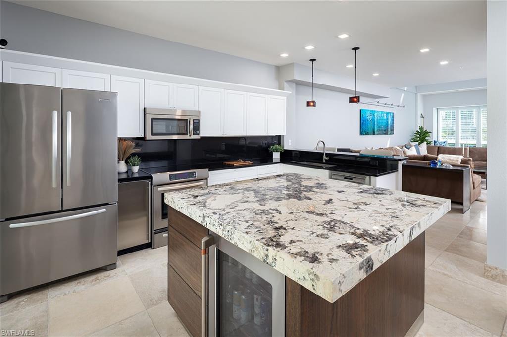 1070 5th Street South Naples, FL 34102 - Photo 6 of 23 a kitchen with kitchen island counter top space and refrigerator