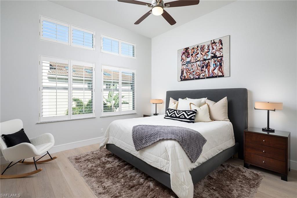 1070 5th Street South Naples, FL 34102 - Photo 9 of 23 a spacious bedroom with a bed a couch and a window