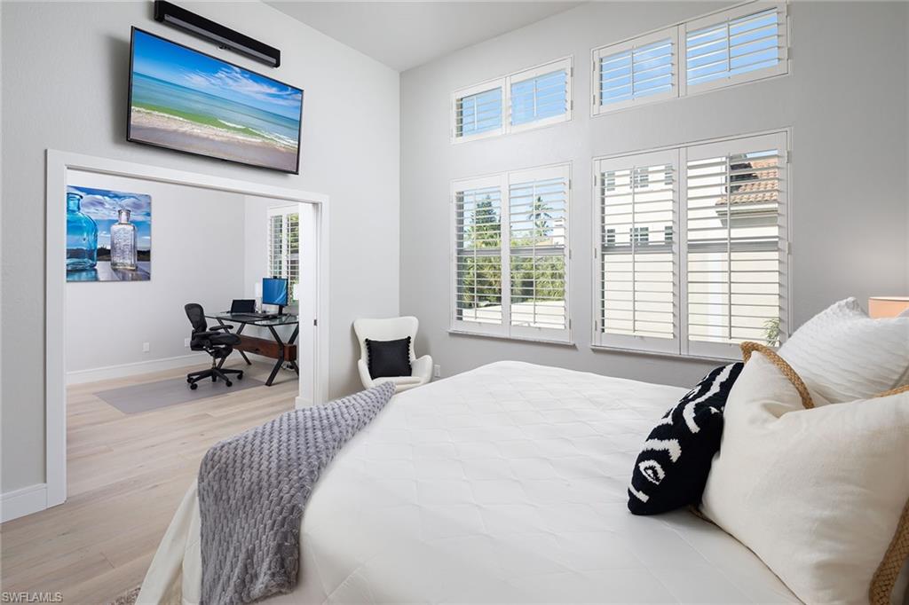 1070 5th Street South Naples, FL 34102 - Photo 10 of 23 a bed room with a bed and a chair