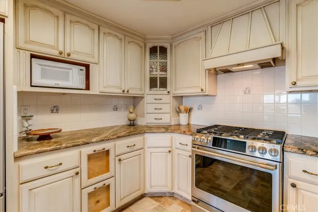 a kitchen with granite countertop cabinets stainless steel appliances and a sink