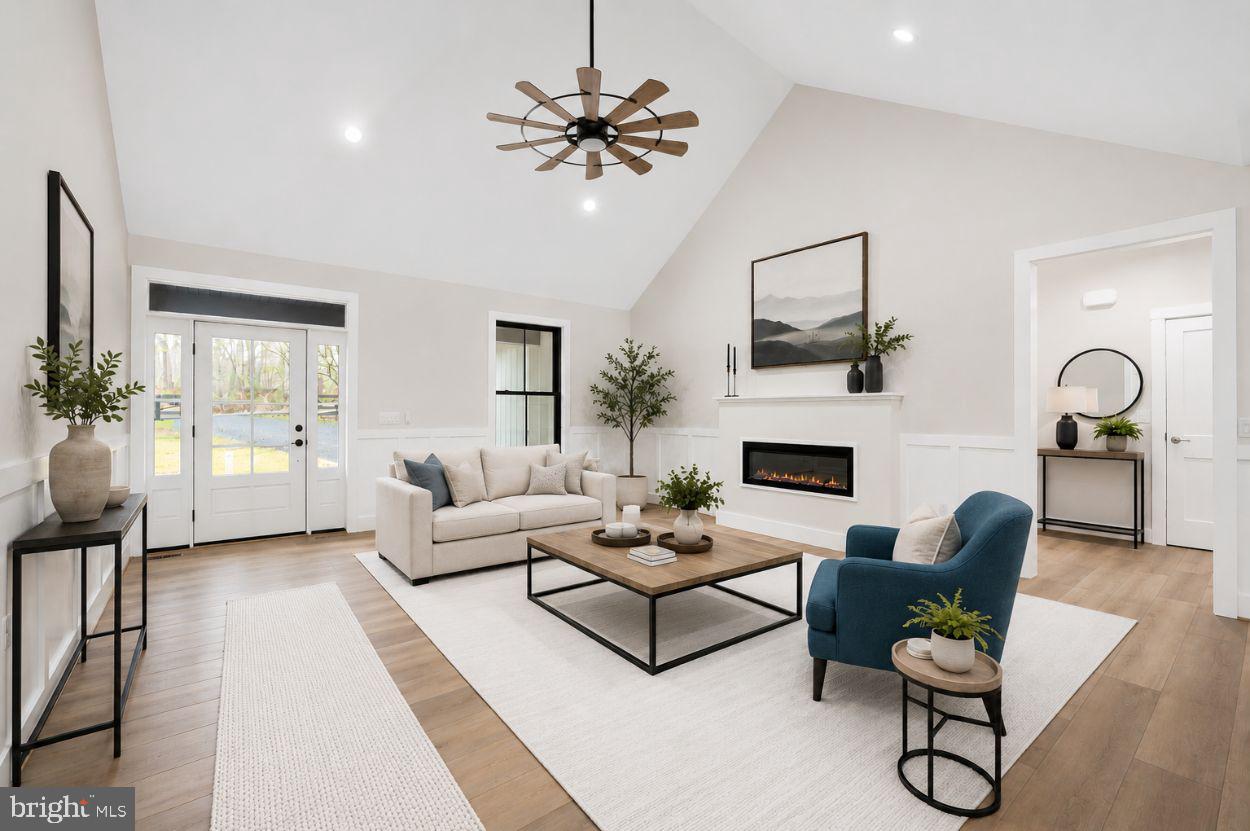 75 Sleepy Hollow Road Linden, VA 22642 - Photo 2 of 19 a living room with furniture a fireplace and a chandelier