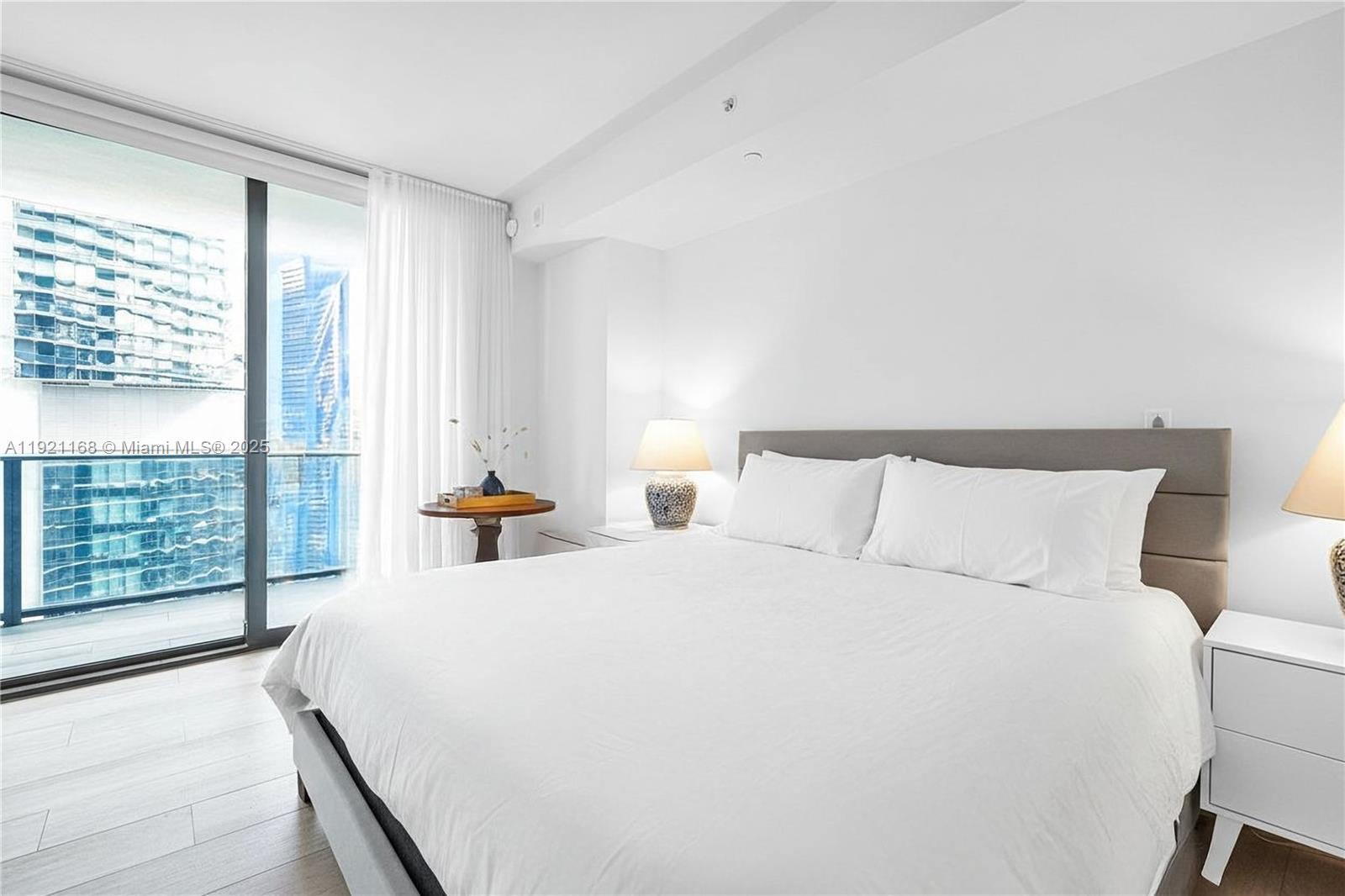 45 Southwest 9th Street, Unit 2901 Miami, FL 33130 - Photo 15 of 29 a bed room with a bed and a night stand