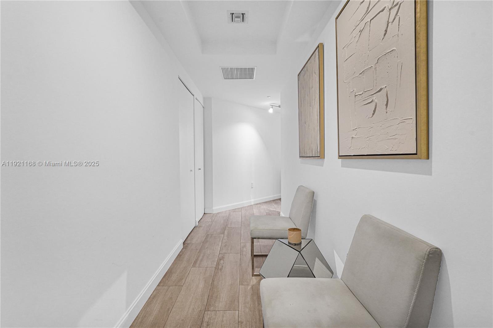 45 Southwest 9th Street, Unit 2901 Miami, FL 33130 - Photo 28 of 29 a view of a hallway with furniture and wooden floor