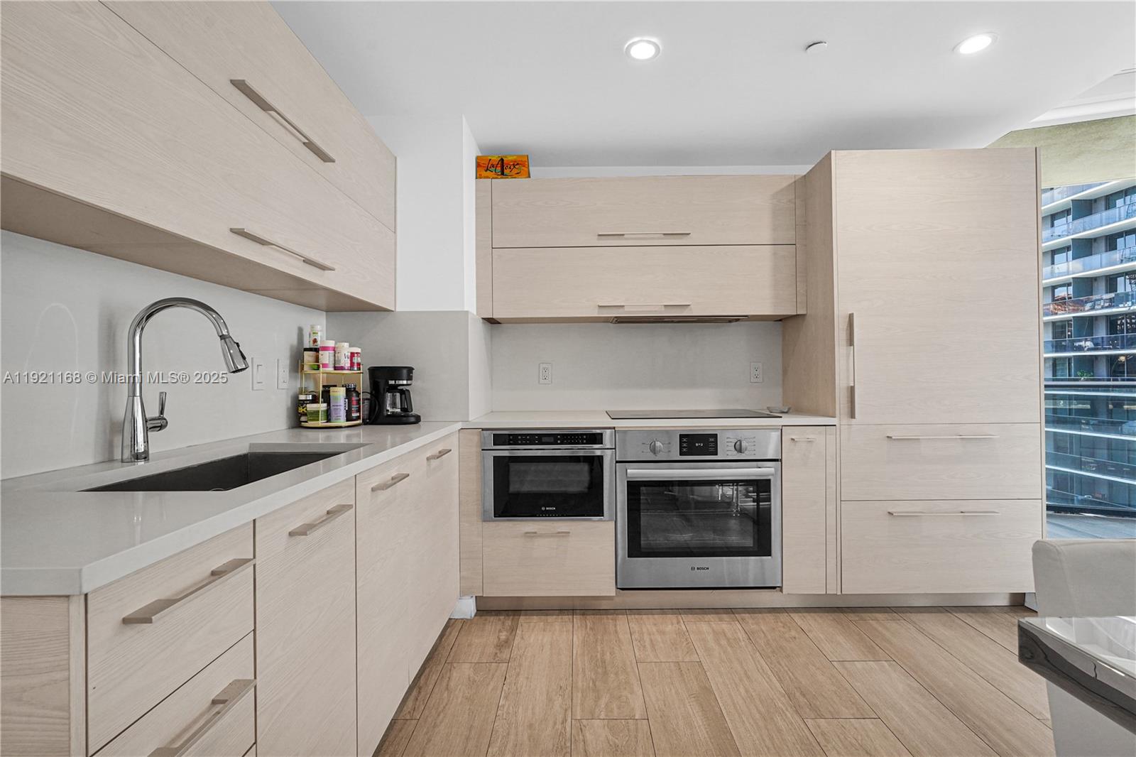 45 Southwest 9th Street, Unit 2901 Miami, FL 33130 - Photo 4 of 29 a kitchen with stainless steel appliances a stove a sink and a microwave