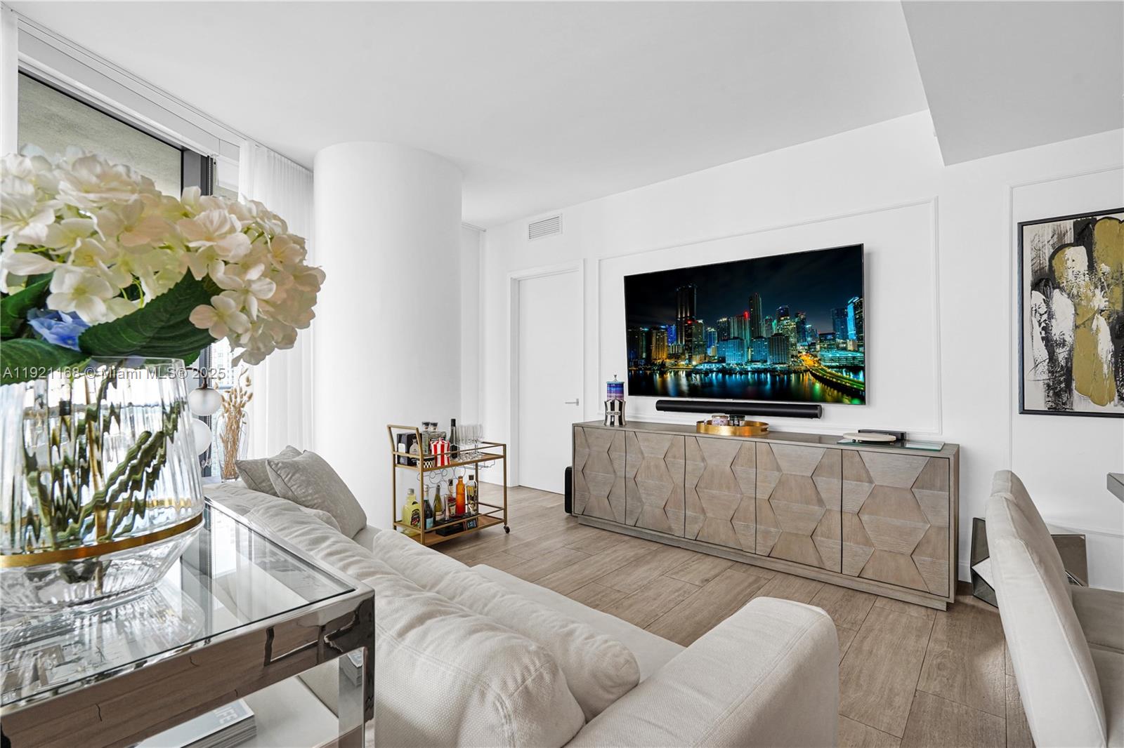 45 Southwest 9th Street, Unit 2901 Miami, FL 33130 - Photo 7 of 29 a living room with furniture and a flat screen tv