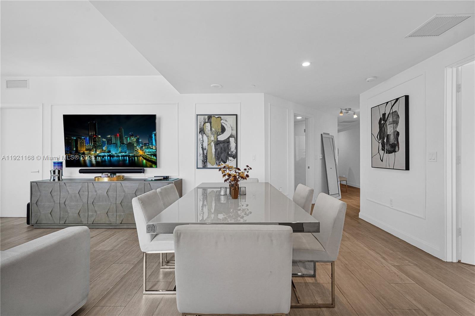 45 Southwest 9th Street, Unit 2901 Miami, FL 33130 - Photo 8 of 29 a dining room with furniture and a flat screen tv