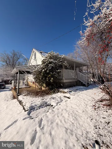 a view of a house with a yard covered in snow