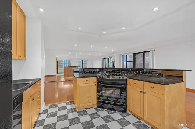 a kitchen with stainless steel appliances granite countertop a sink stove and cabinets