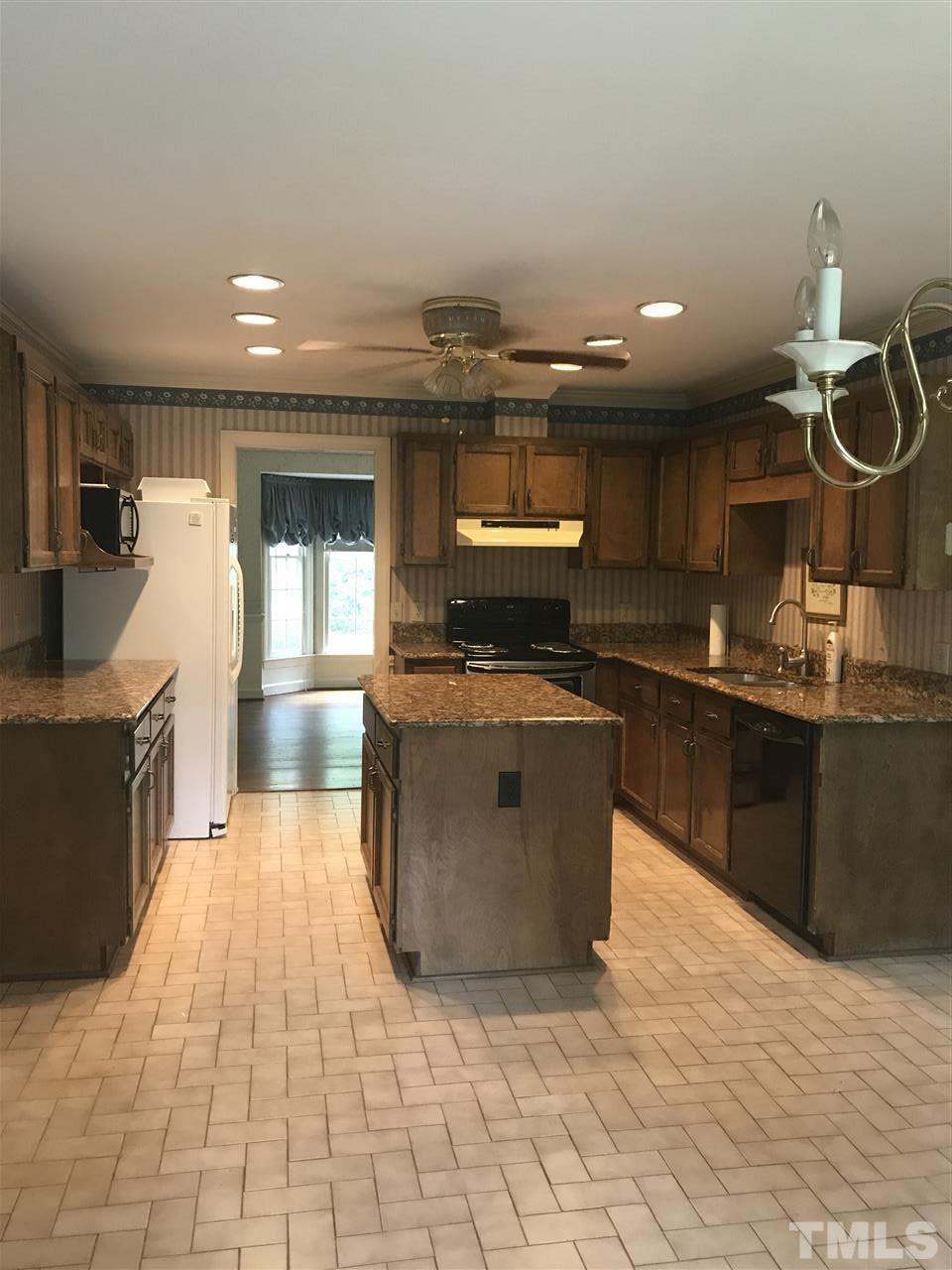 2907 Dunhaven Drive Garner, NC 27529 - Photo 10 of 25 a kitchen with stainless steel appliances granite countertop a sink and a stove