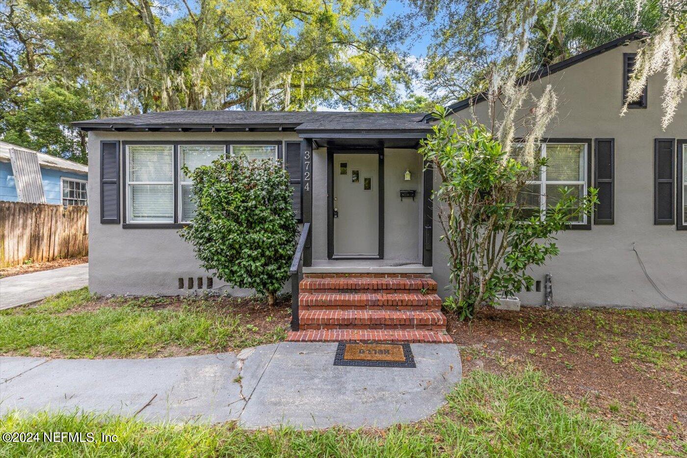 3724 South Lilly Road Jacksonville, FL 32207 - Photo 2 of 21 a front view of a house with a garden