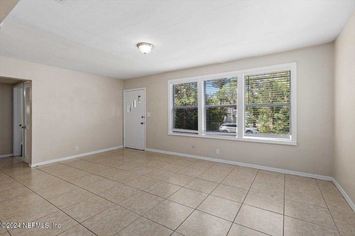 3724 South Lilly Road Jacksonville, FL 32207 - Photo 3 of 21 a view of an empty room with a window