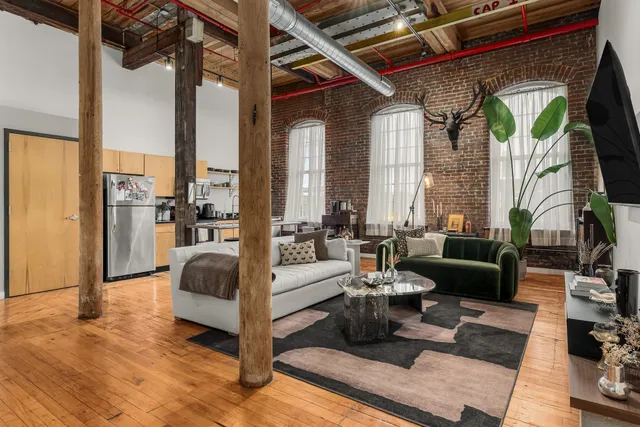 a living room with furniture and a fireplace