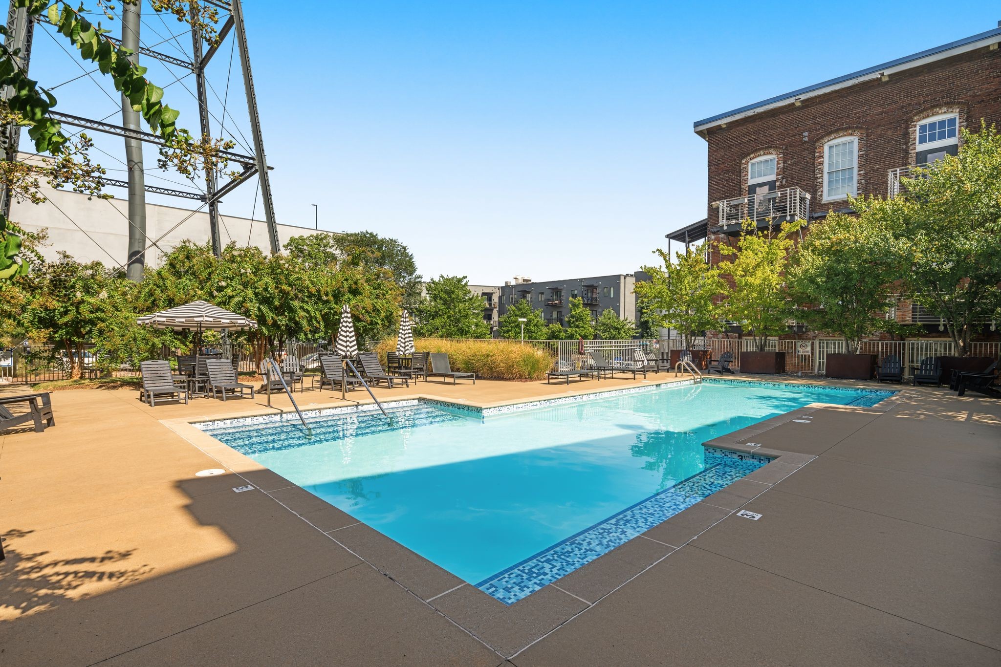 1400 Rosa L Parks Boulevard, Unit 211 Nashville, TN 37208 - Photo 24 of 36 a view of a swimming pool with lawn chairs and plants