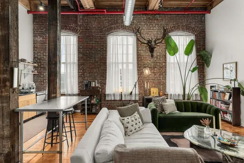 a living room with furniture and a fireplace
