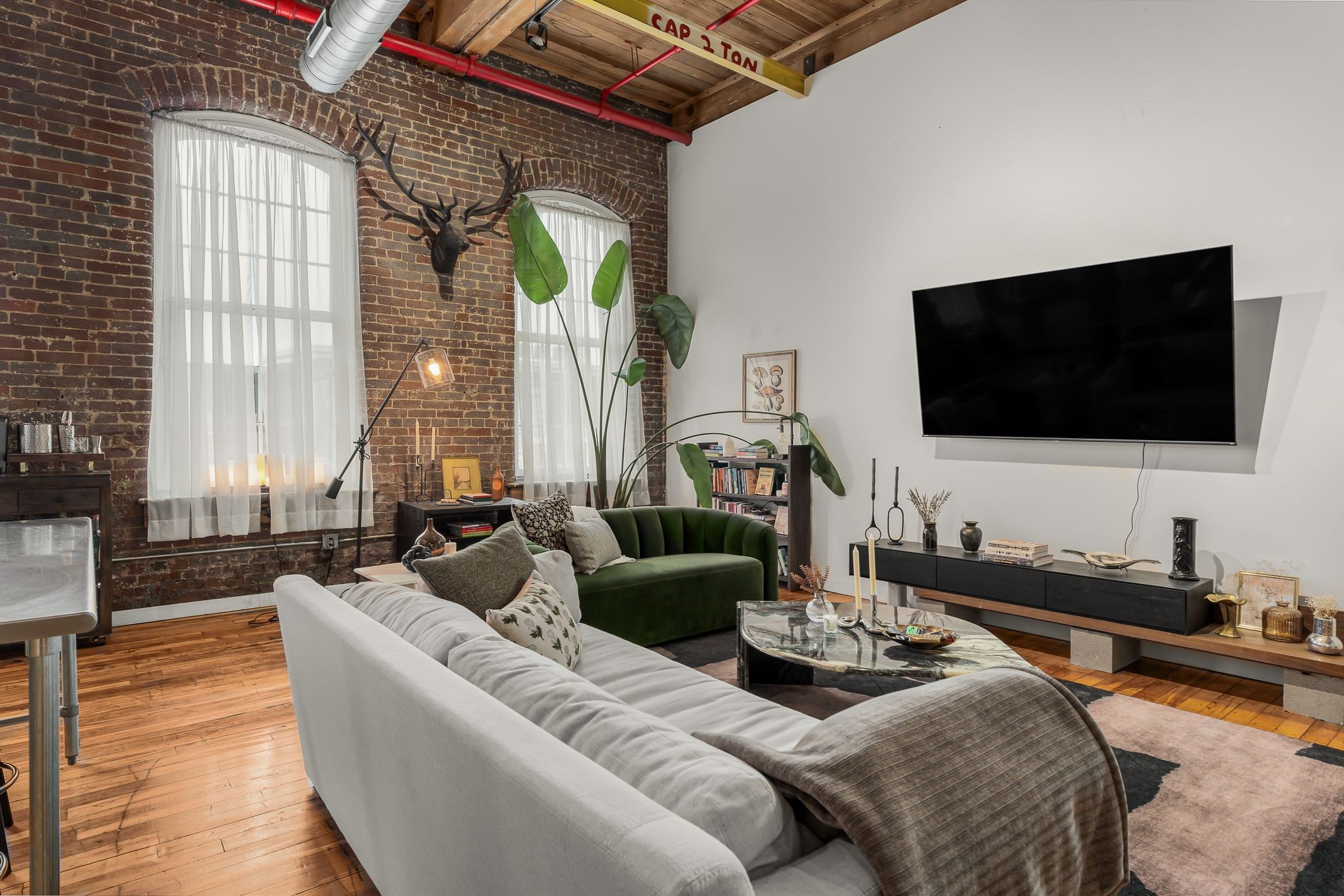 1400 Rosa L Parks Boulevard, Unit 211 Nashville, TN 37208 - Photo 5 of 36 a living room with furniture and a flat screen tv