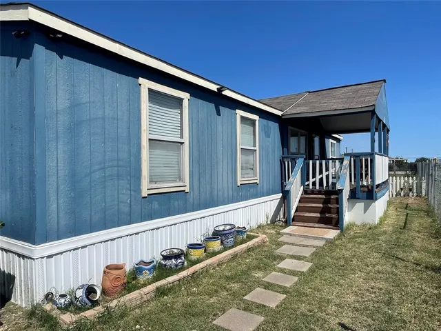 a view of a house with backyard and wooden floor
