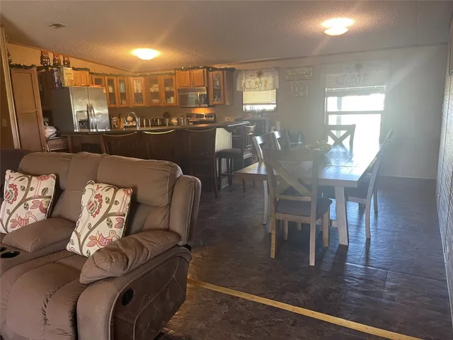 a living room with lots of furniture and a wooden floor