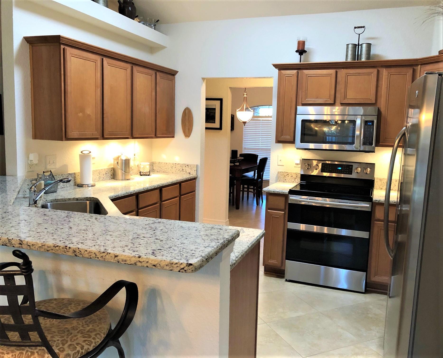 44 East Shipwreck Road Santa Rosa Beach, FL 32459 - Photo 15 of 33 a kitchen with a sink a stove and chairs