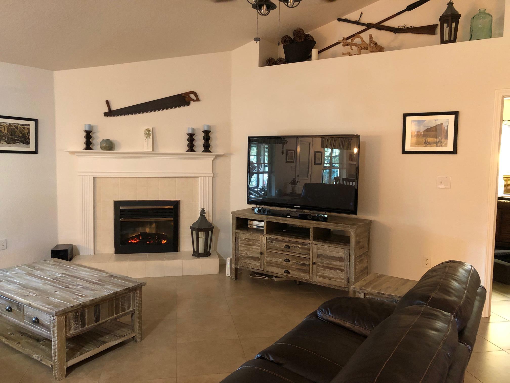 44 East Shipwreck Road Santa Rosa Beach, FL 32459 - Photo 16 of 33 a living room with furniture a flat screen tv and a fireplace