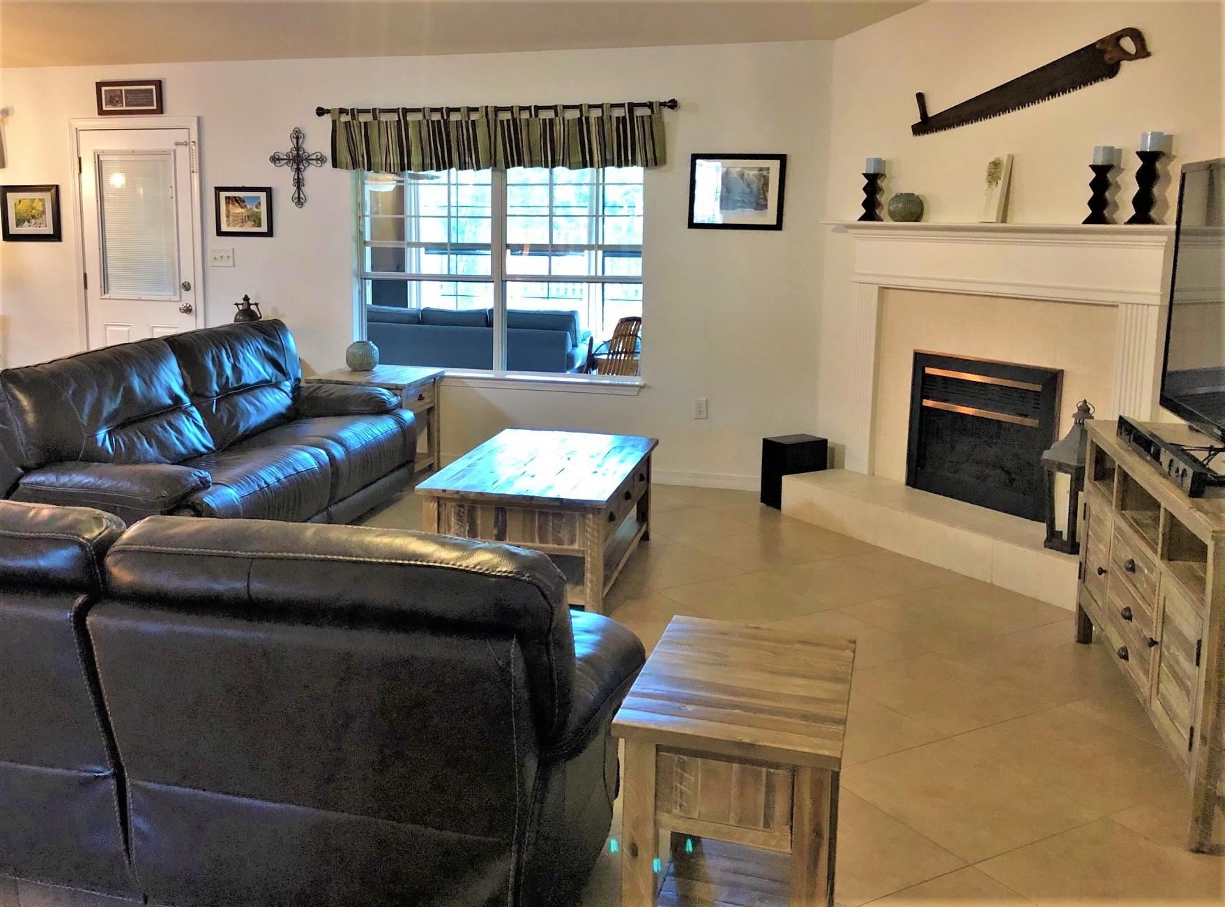44 East Shipwreck Road Santa Rosa Beach, FL 32459 - Photo 22 of 33 a living room with furniture a fireplace and a flat screen tv