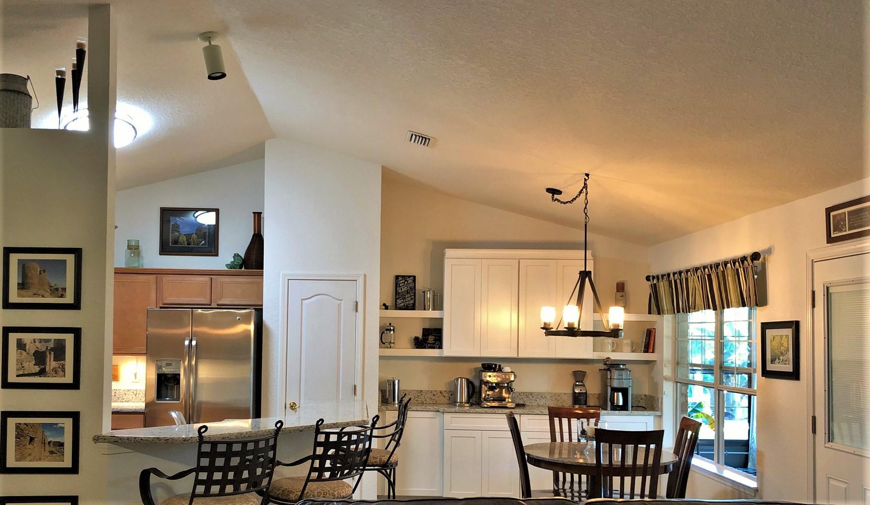 44 East Shipwreck Road Santa Rosa Beach, FL 32459 - Photo 27 of 33 a view of dining room and livingroom with furniture wooden floor a chandelier