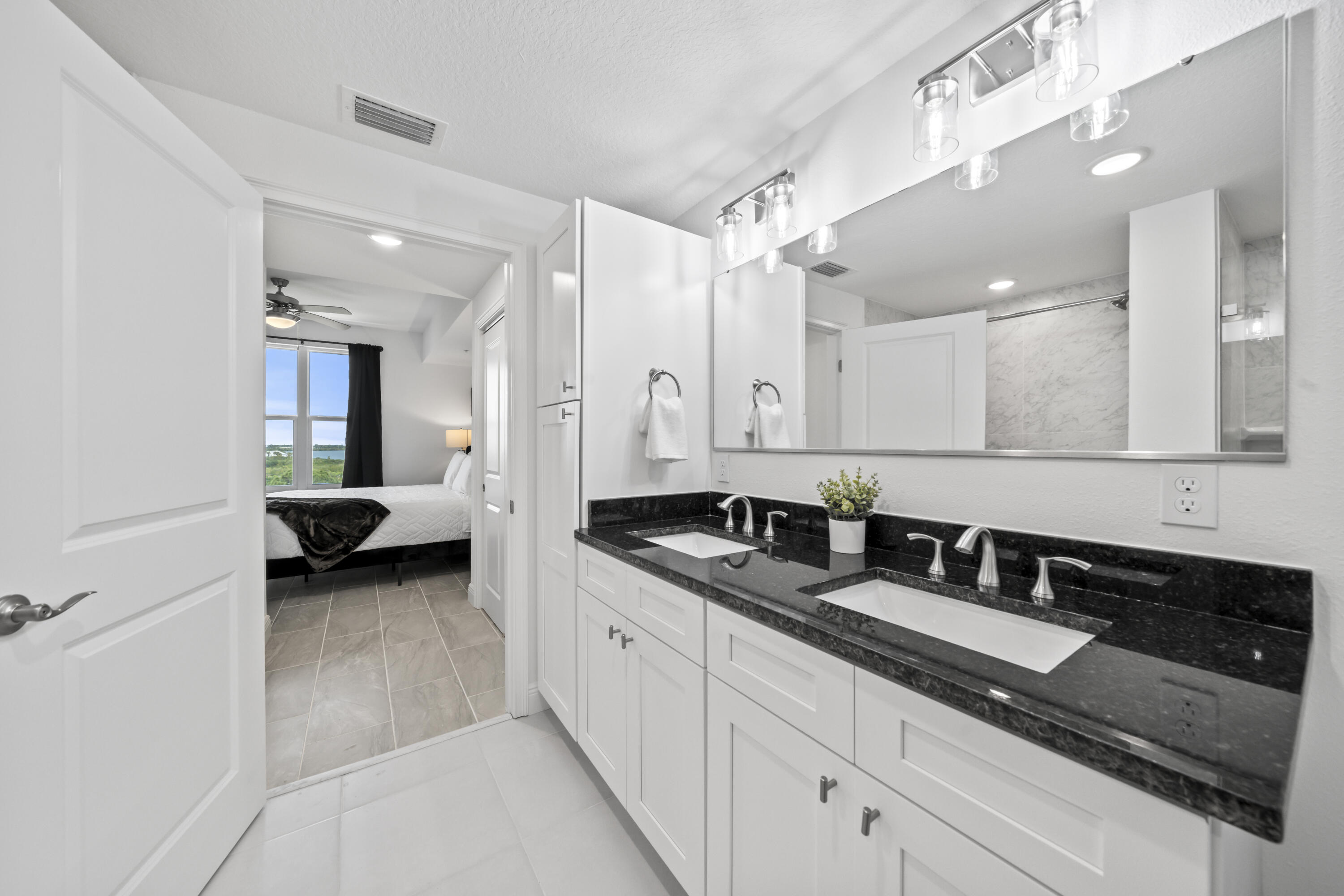 735 Pilot Lane, Unit 1004 Merritt Island, FL 32952 - Photo 19 of 46 a en suite bathroom with double sink and a mirror