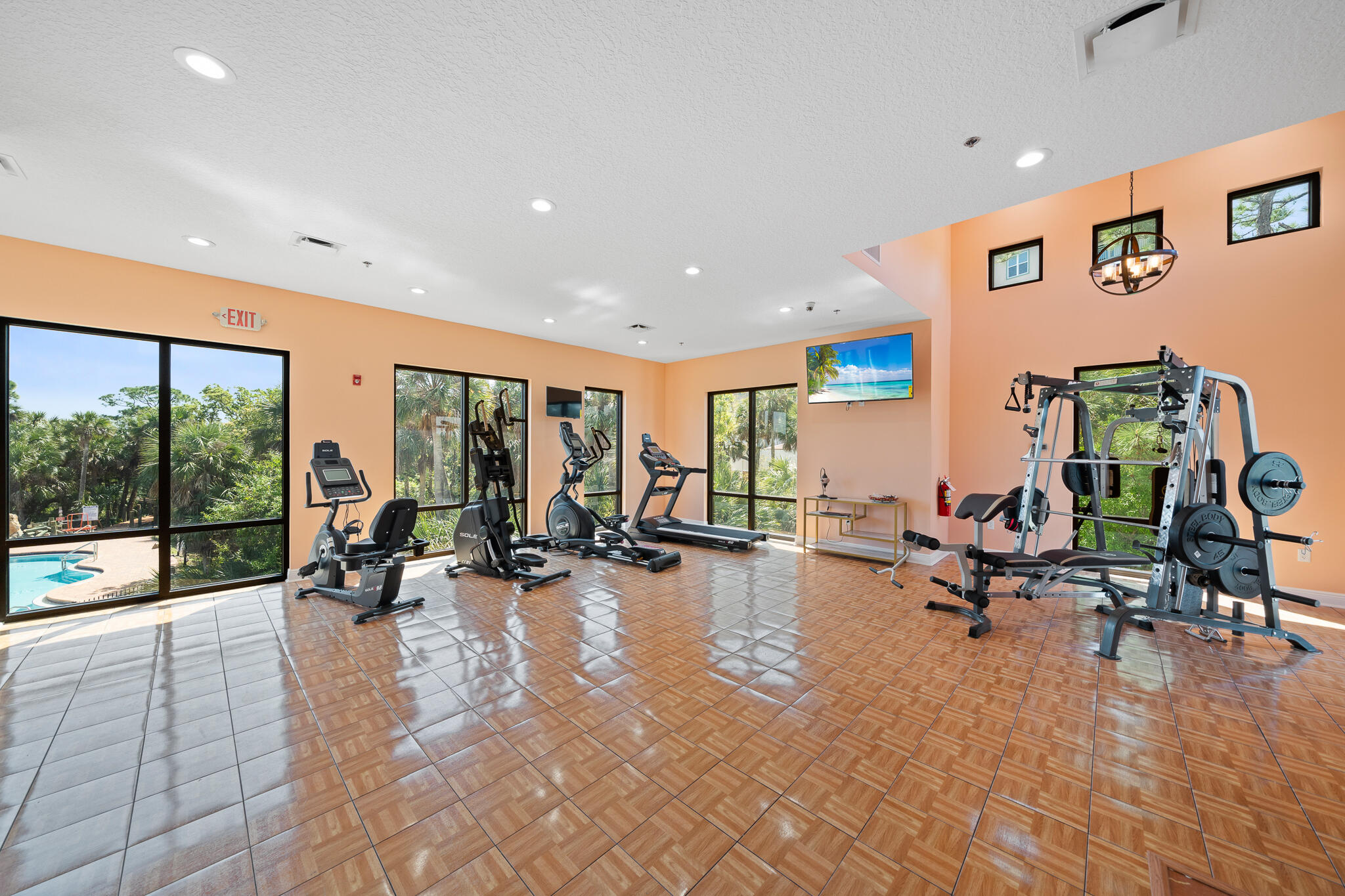 735 Pilot Lane, Unit 1004 Merritt Island, FL 32952 - Photo 26 of 46 a view of a room with gym equipment and floor to ceiling window